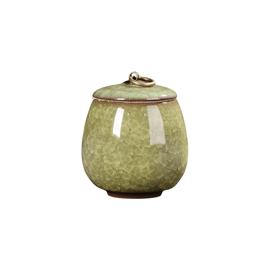 Lichtgroene keramische urn met craquelé-glazuur, ronde vorm, bronzen ring op de deksel