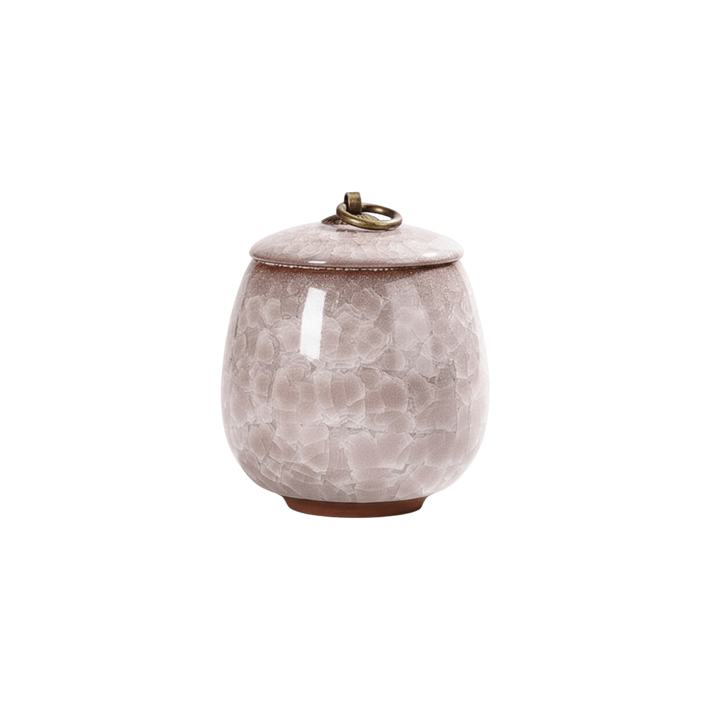 Lichtroze keramische urn met craquelépatroon, ronde vorm, bronzen ring op de deksel