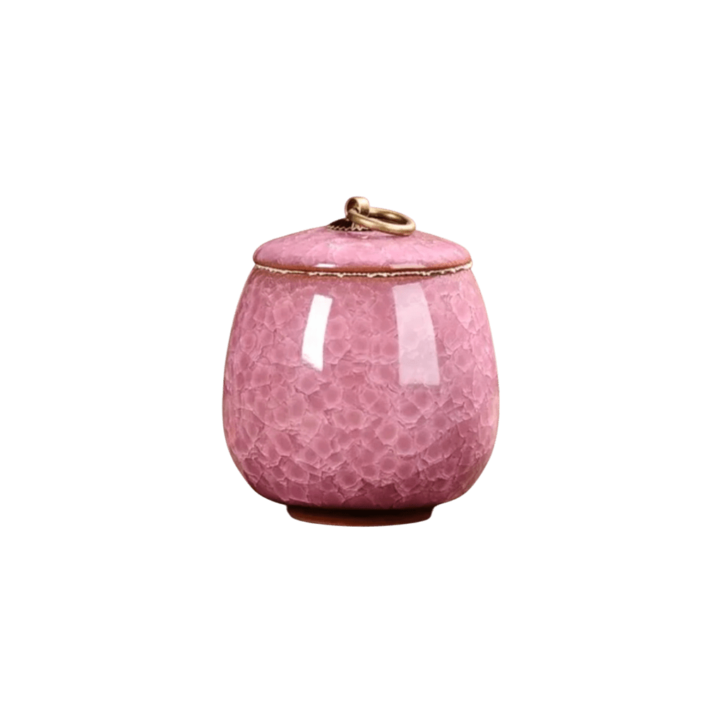 Roze keramische urn, ronde vorm, met craquelé glazuur en gouden rand en handvat