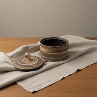 Keramische bruine urn met eikenhout-look strepen, ronde vorm, touw op deksel